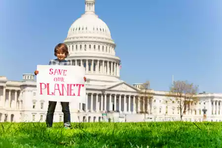 Protester holding sign save our planet in hands